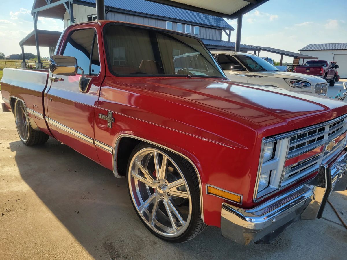 Restored red classic pickup with dark window tint