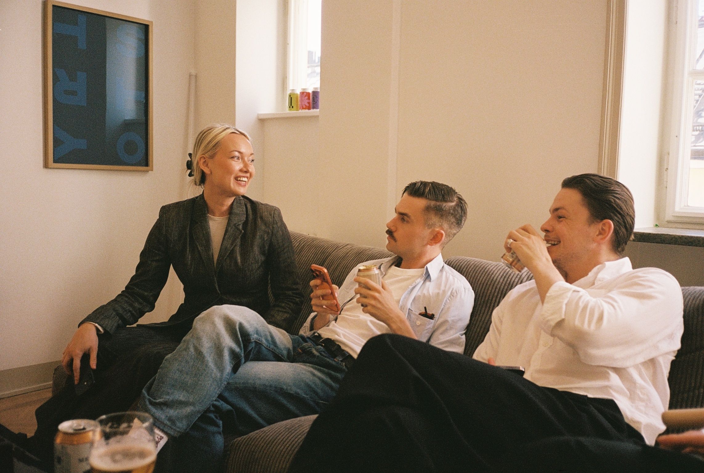 Three colleagues talking on a sofa