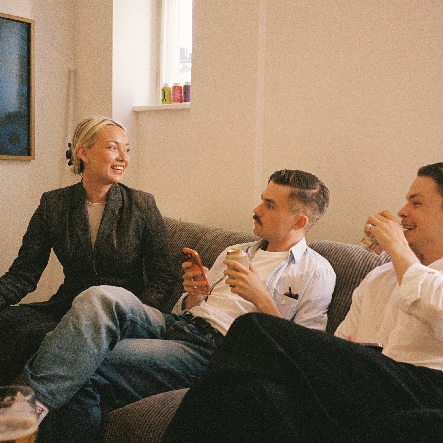 Three colleagues talking on a sofa