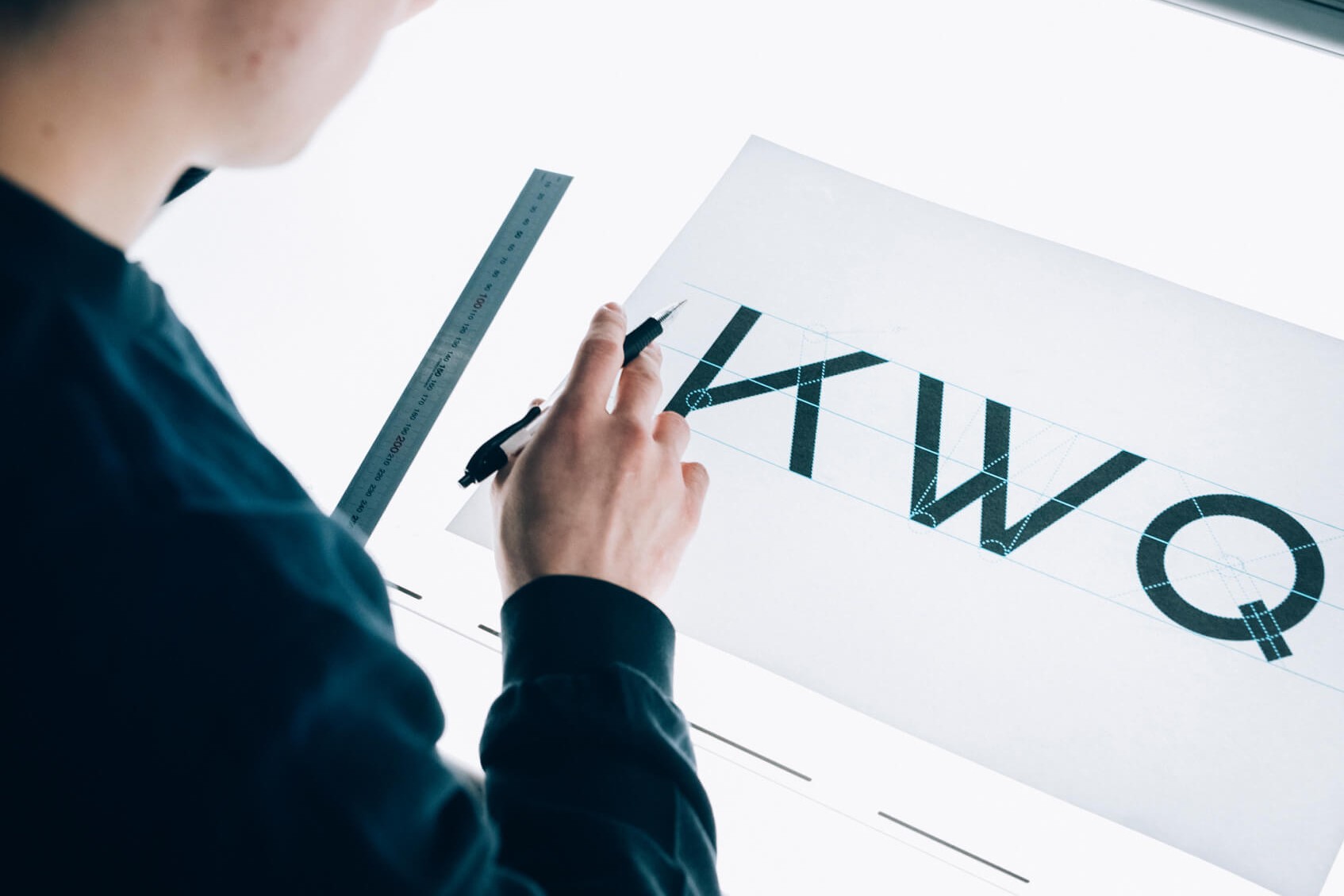 A close detail of Bauhaus type characters set as a specimen, showing the revived typeface's letterforms.
