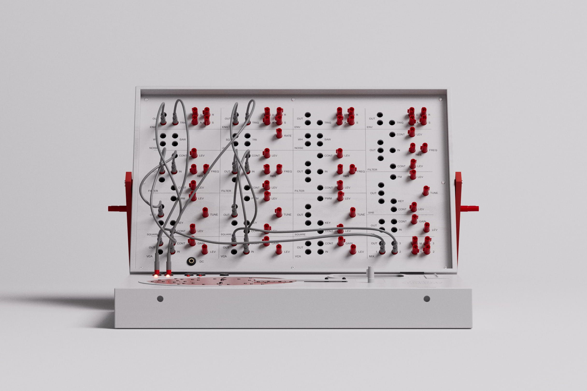 White modular synthesizer with red jacks and grey patch cables.