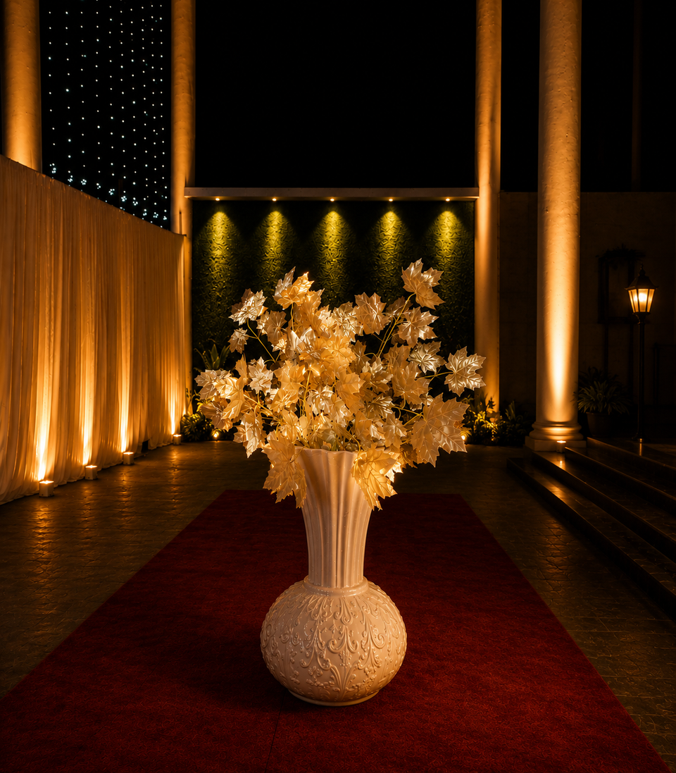 Lit floral urn on the red carpet at the entrance