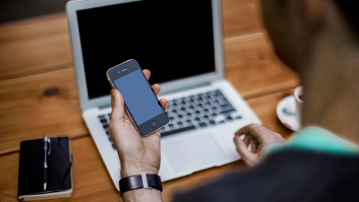Smart Home Features Luxury Buyers Expect in Aspen – Man with smartphone and laptop (Unsplash)