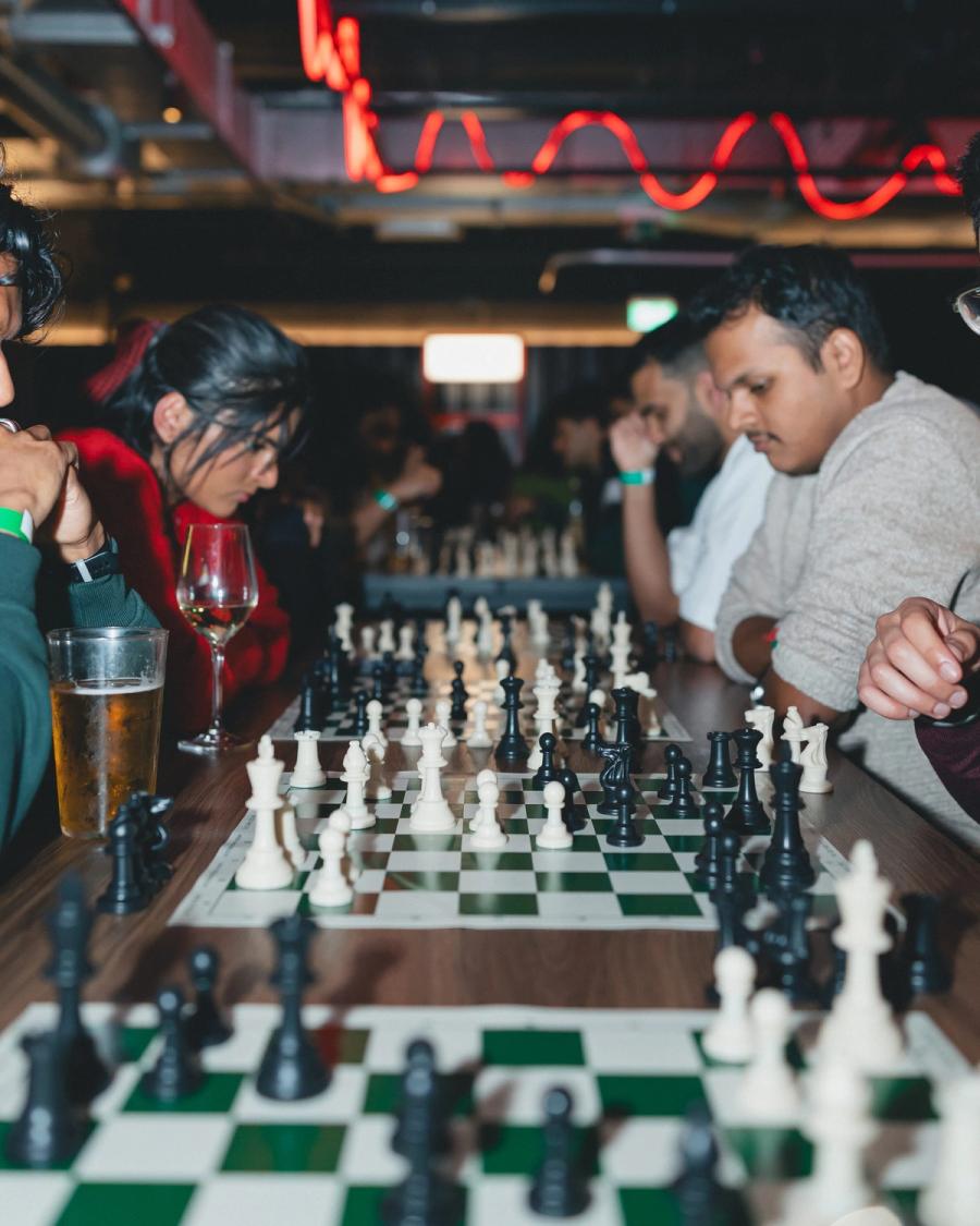 A long row of boards in play at a sell-out BACA Chess night