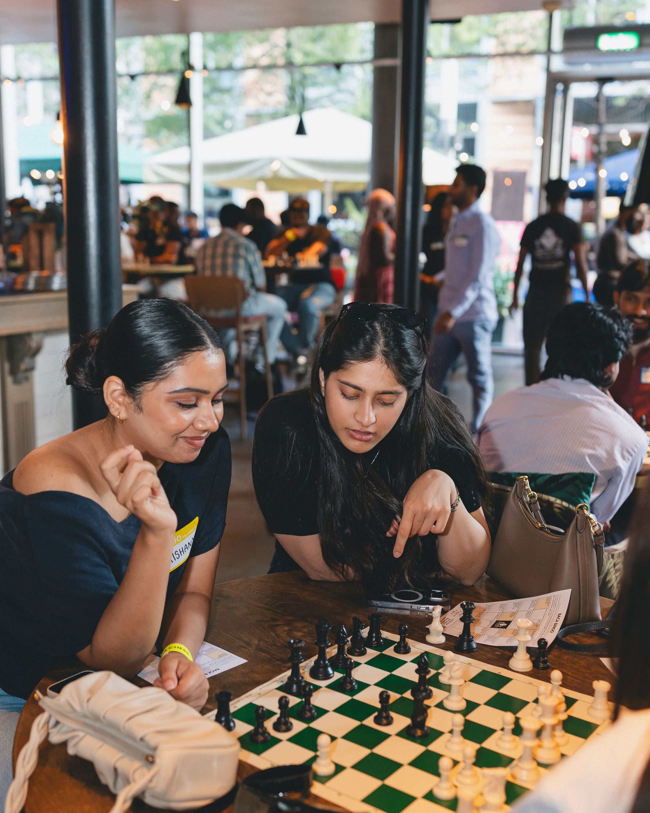One player pointing out a move to another across the board