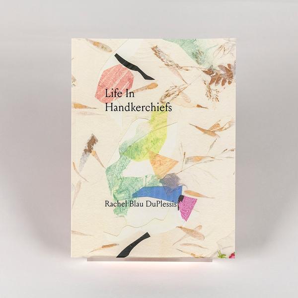 A photo of a paperback book titled "Life in Handkerchiefs" by Rachel Blau DuPlessis. The cover has a cream, textured background with colorful abstract bits of paper collaged and drawn on the surface.