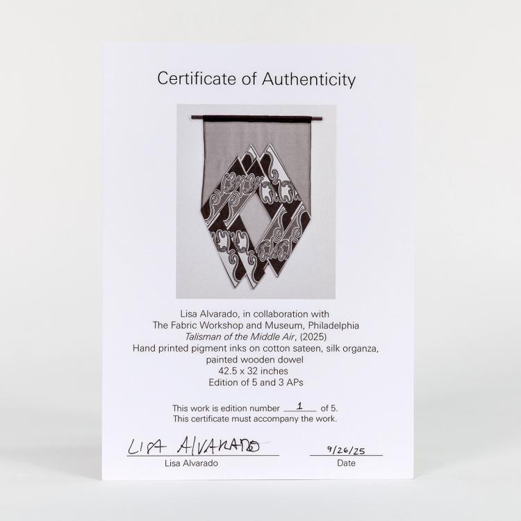 A photo of white cardstock representing a certificate of authenticity for the artist edition, Talisman of the Middle Air, by Lisa Alvarado
