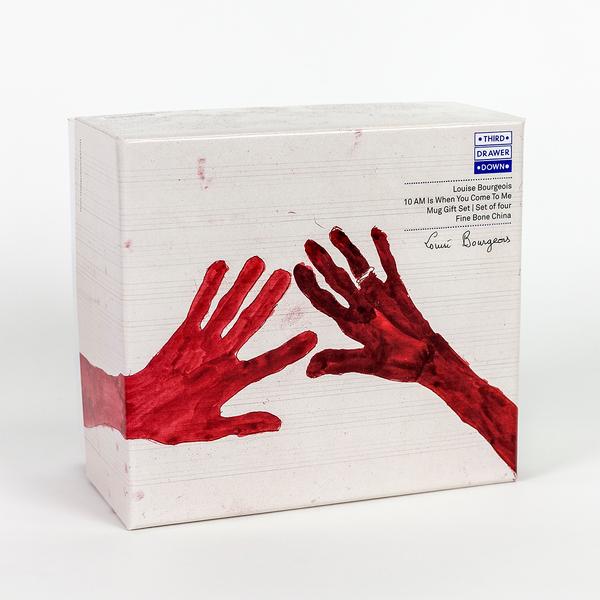 A box with a painting of two red hands with fingers outstretched. The hand on the right has a ring on its ring finger.