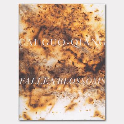 An image of a cover of a book that reads: "Cai Guo-Qiang Fallen Blossoms." The cover imagery is of paper that has burn marks.