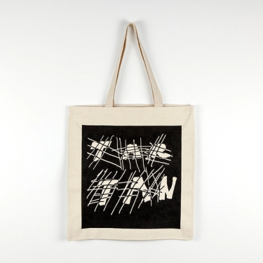 A cream colored canvas tote with a black ink square screenprinted over the front of the bag. The negative space in the print has crosshatched lines intersecting with thick handwritten text that reads "TAR" on the top line and "TAN" below.