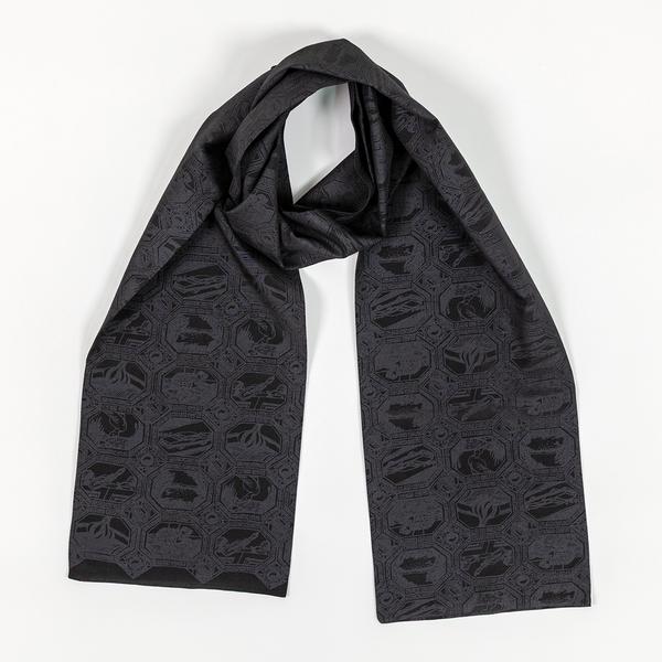 A charcoal black scarf with a grid of octagonal vignettes also printed in black. Each features an abstract composition. The scarf is wrapped loosely as if to allow space for a wearer's neck at the center.