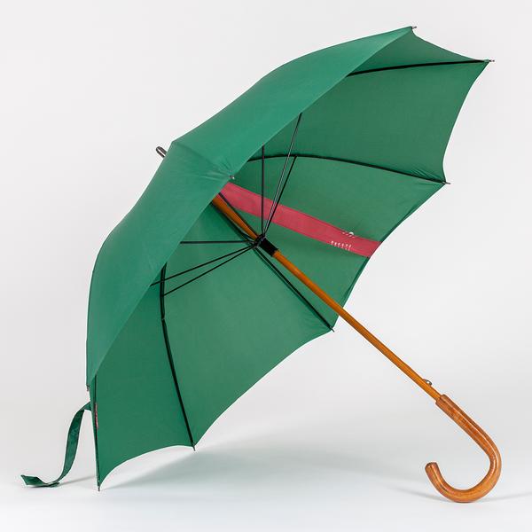 A photograph of the inside of a green umbrella with a wooden handle. There is a red strip of fabric sewn from the top to the bottom of the umbrella, suggesting to be used as a sun dial.