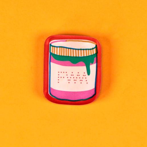 A tool magnet in the form of a red outlined jar of ink is laid out against a bright, warm yellow background. Cartoon drips of green ink ooze from the lid over the jar, which has a FWM logo on its label.