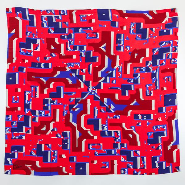 A square scarf featuring a pixelated pattern of reds and blues reflected into four quadrants along an X