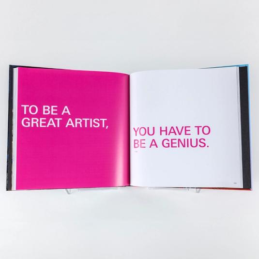 A book spread featuring two pages of large text. The left side reads, "To be a great artist," with a pink background and white text. The right side reads, "you have to be a genius." on a white background with pink text.