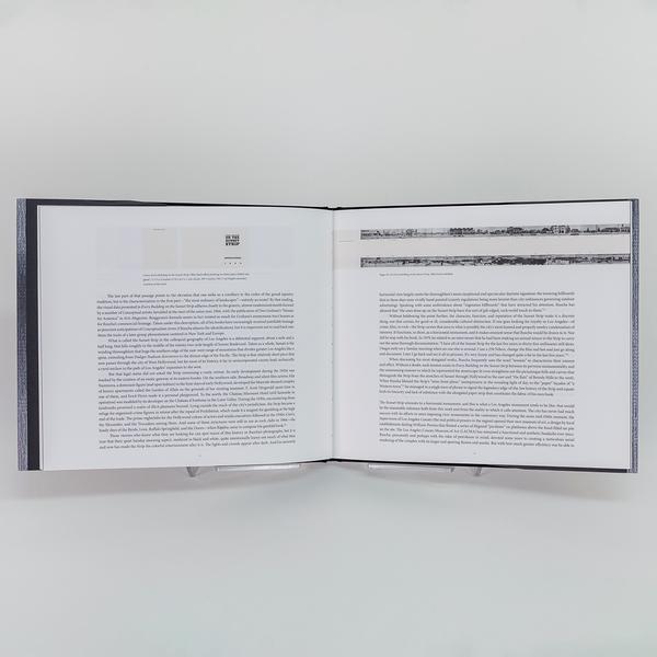 A photograph of an open book with paragraphs of text.