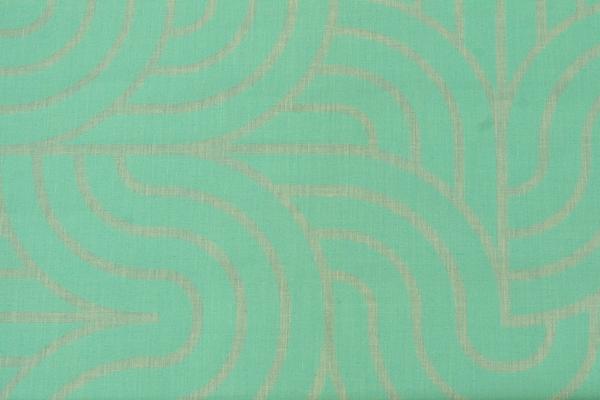 An image of a flat woven teal fabric. Screenprinted on the fabric is a slightly more vibrant pattern of thick teal lines creating abstract shapes.