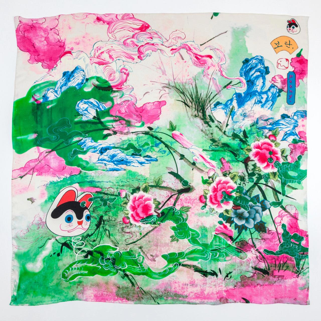 A square scarf with fluid ink drawings of pink, green, and blue clouds, intersect with drawings of mountains and peonies in an East Asian style. A drawing of a cartoon cat head floats on the left. 