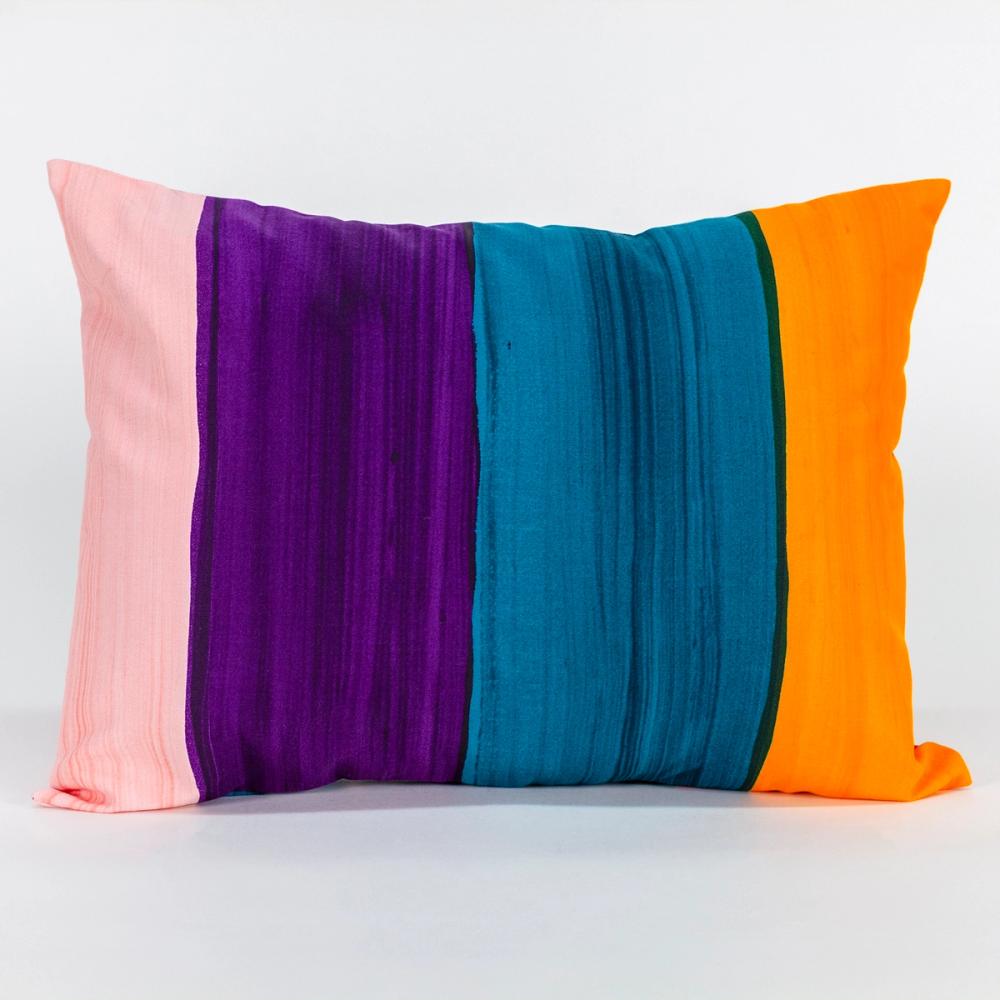 A wide rectangular pillow featuring painted vertical stripes of, purple, teal, ochre, and light pink.