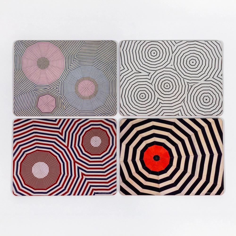 A series of four hard placemats with curved edges. The design of each placemat features various striped patterns, each cut into triangles and sewn together to create circle-like shapes.