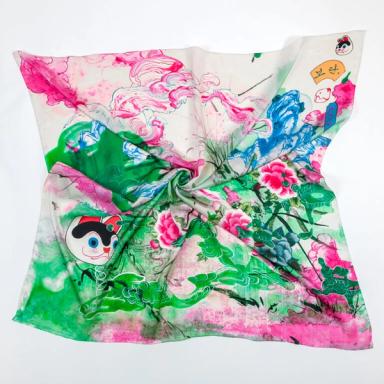A square scarf twisted in the middle. Its image features fluid ink drawings of pink, green, and blue clouds that intersect with drawings of mountains and peonies in an East Asian style. A drawing of a cartoon cat head floats on the left. 