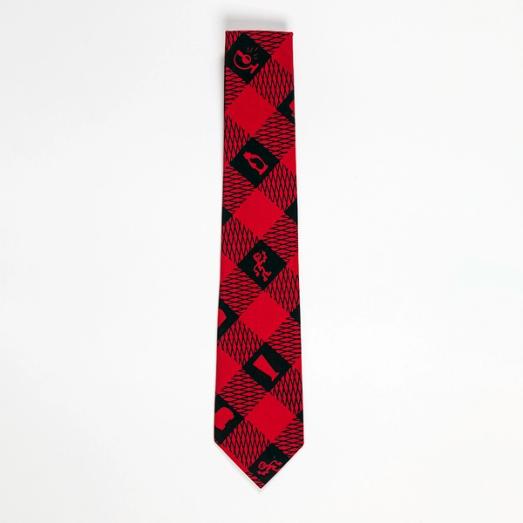 A red and black checkerboard-style necktie with silhouettes of figures and objects in the recurring black squares.