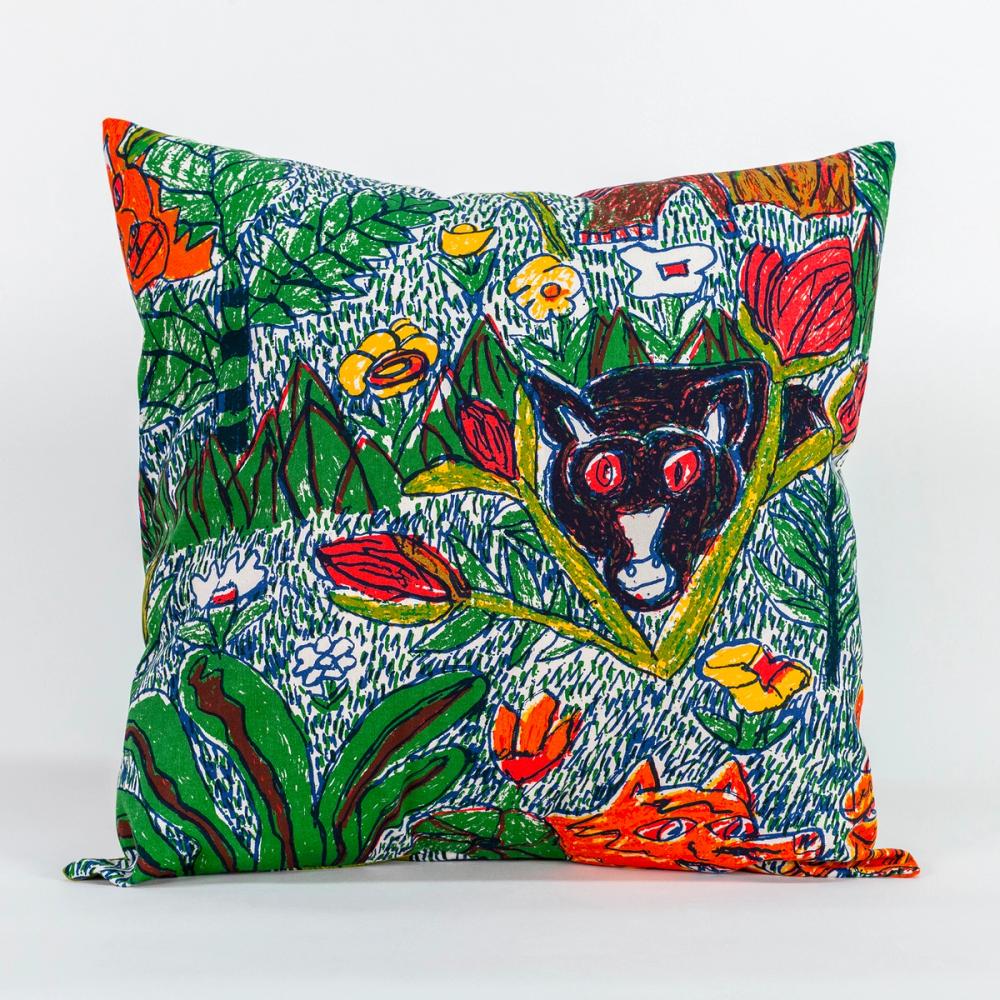 A photo of a square decorative pillow. The pattern on the pillow features a colorful design of hand-drawn leafy foliage, flowers, and wild creatures.