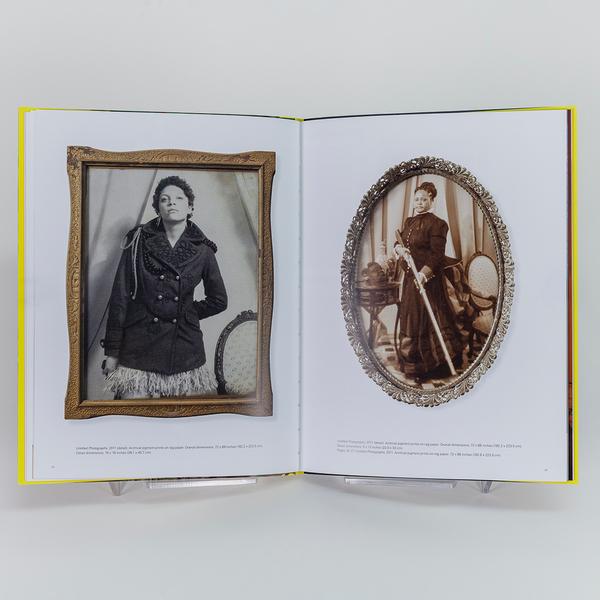 A photograph of an open book with each page showing a vintage framed sepia photograph of a woman.