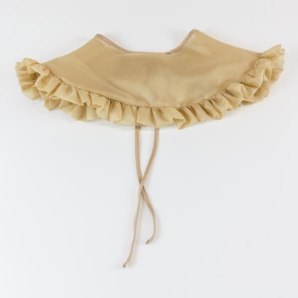 A tan silk organza removable collar is lying with the back facing upwards flat against a white background. It is slightly sheer and has a ruffle around the outer edge.