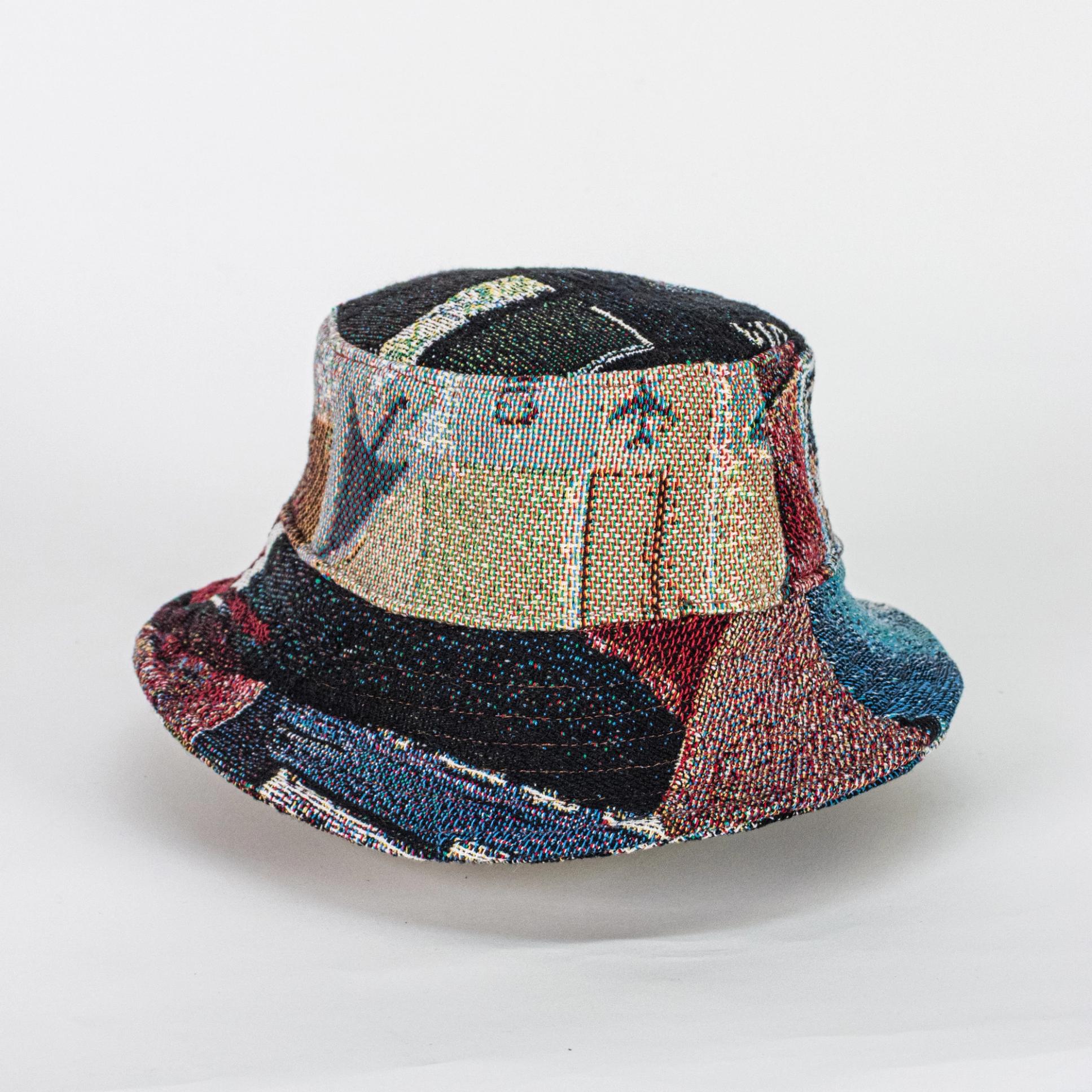 A jacquard-woven bucket hat depicting textures, colors, and symbols of computers. This view specifically features a cursor pointing downward on the side of the bucket hat.