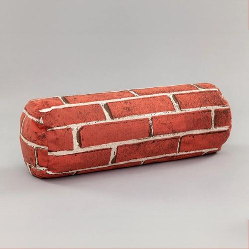 A cylindrical pillow laying on its side featuring a red brick pattern.