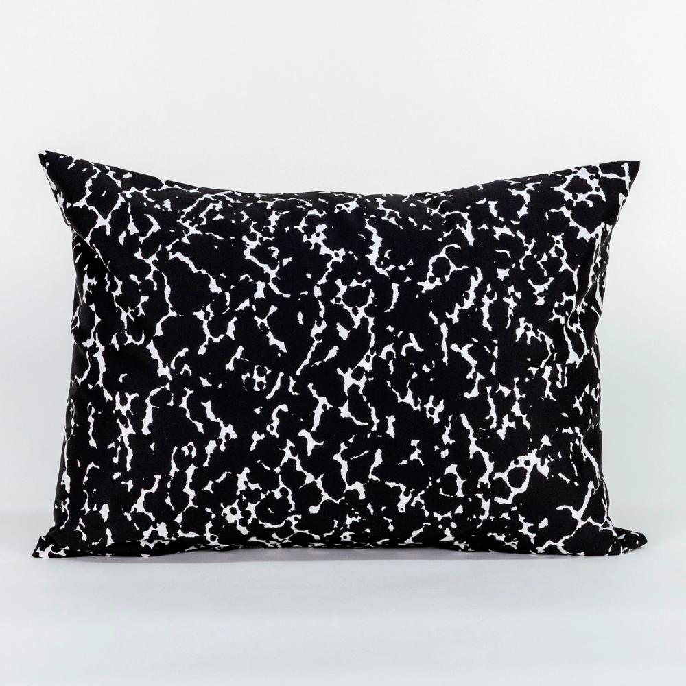 A wide rectangle-shaped pillow featuring a speckled black and white design like the kind found on a student's composition notebook.
