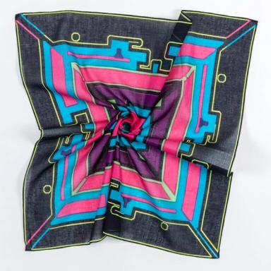 A square scarf twisted in the middle, pulling its edges inward.  This scarf is primarily black, blue, and bright pink, with a purple border around the inner design and neon green accents.