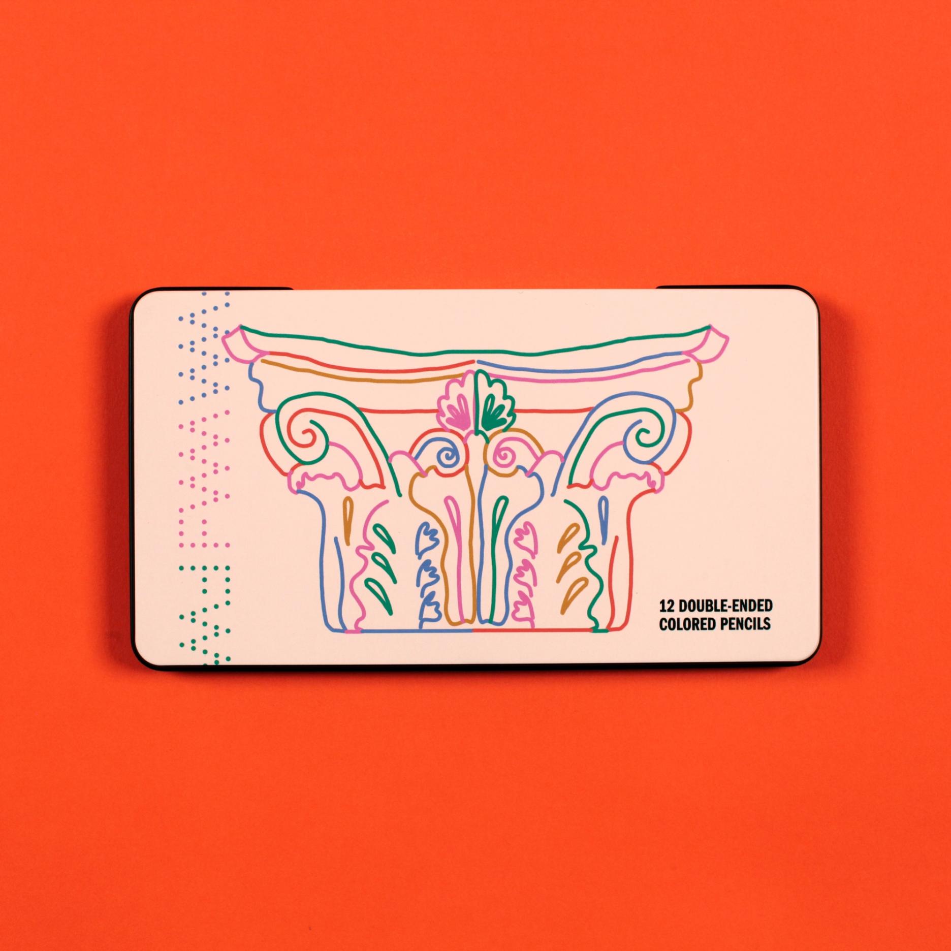 A cream pencil case sits against a bright tomato red orange background. Its cover features a colorful line drawing of a corinthian column. The text reads "12 double-ended colored pencils"