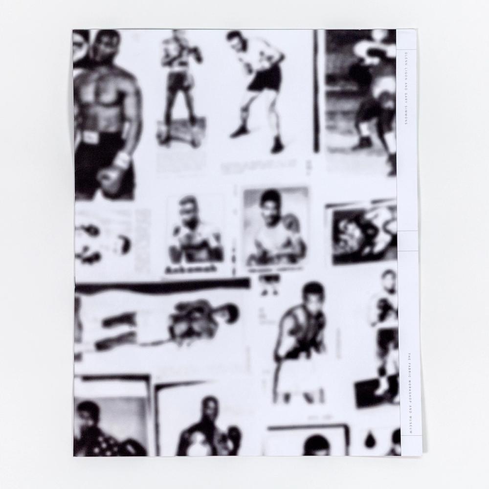 A photograph of a large paperback book. The black and white book cover features out-of-focus photos of many boxers in various poses.