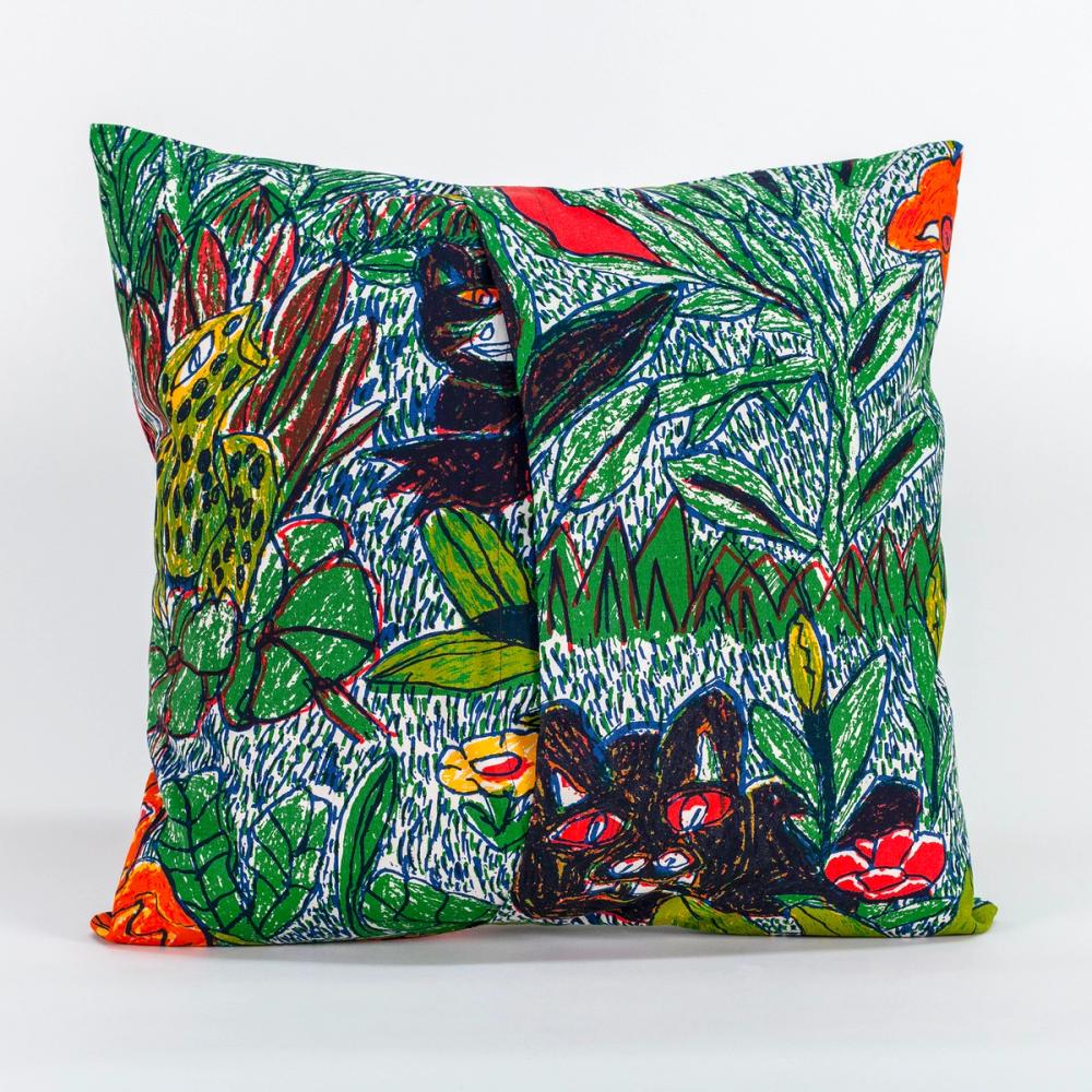 A photo of the back of a square decorative pillow. The pattern on the pillow features a colorful design of hand-drawn leafy foliage, flowers, and wild creatures. The left and right panels of fabric overlap in the center to create an opening.