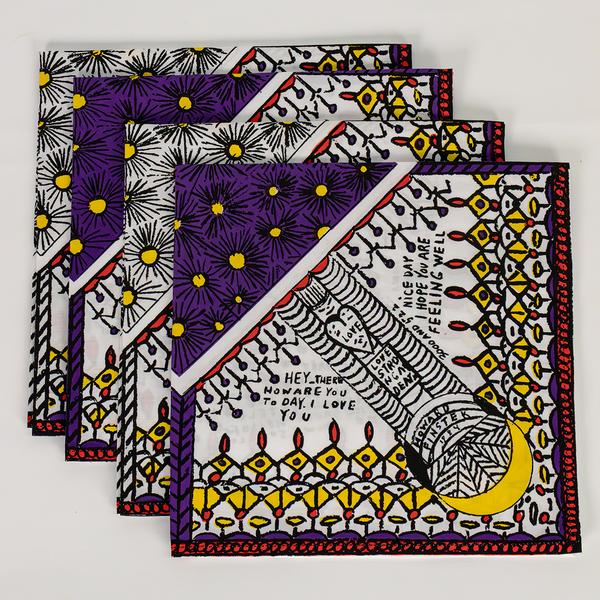 A stack of four decorative napkins offset from one another. The top napkin shows patterns of starbursts and rows of drawn shapes. At the center is a pillar with a heart that says "love" on it and another sign that says "love strong and eat." Nearby, text reads "Hey there, how are you today? I love you" and "nice day. I hope you are feeling well."