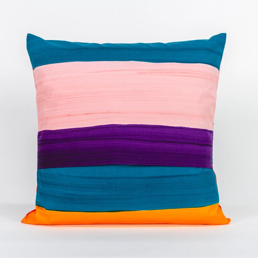 A square pillow featuring painted horizontal stripes of purple, light pink, teal, and ochre. The top and bottom panels of fabric overlap in the center to create an opening.