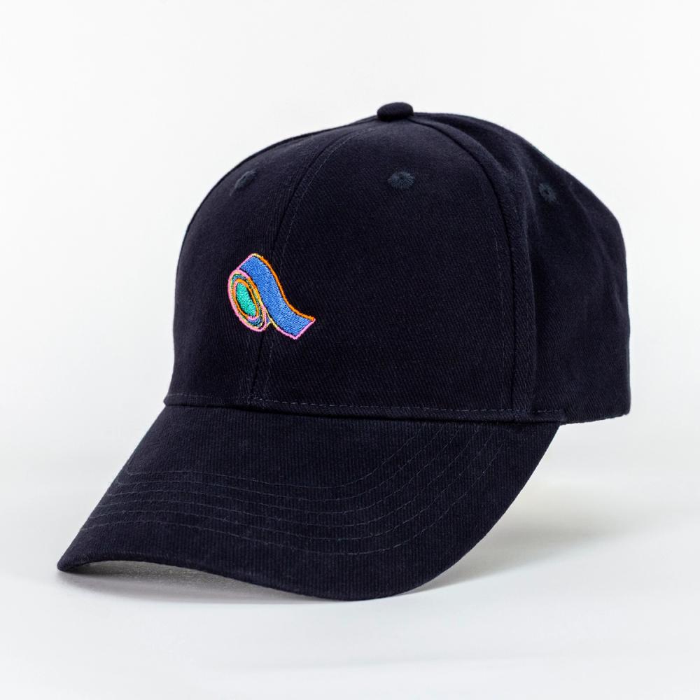A photo of a black baseball cap with an embroidery of blue tape. The center of the tape is green and there is a pink, yellow, and orange outline to the shape of the blue tape.