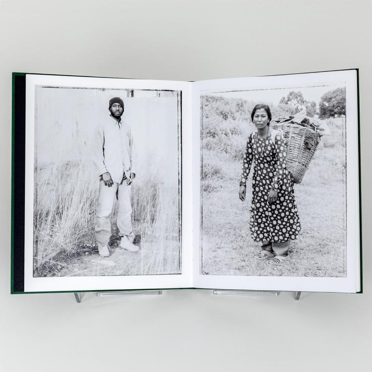 Open photo book displaying two black-and-white portraits: a man standing outdoors on the left page and a woman carrying a large basket on her back on the right page.