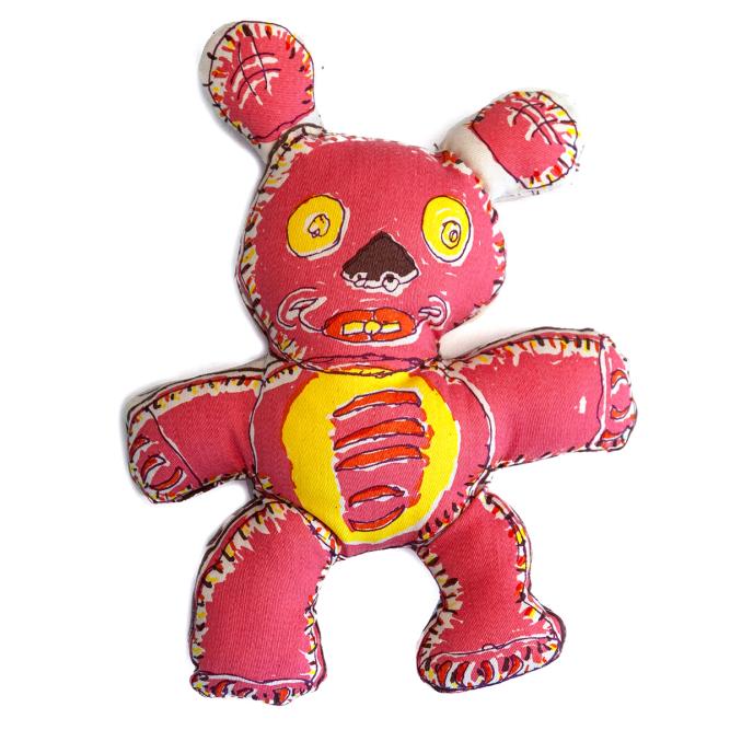A hand-drawn teddy bear plush doll with a mostly dark pink body. It has yellow eyes, a dark brown wedge shape for a nose, and red lips with smile lines. Its yellow belly features alternating swaths of red and pink bands. Neither of its limbs or ears are the same size or shape. The whole bear figure is outlined in a cream bands with dark marks to suggest stitching.