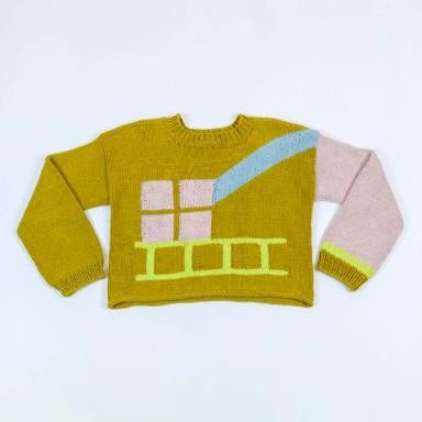 The sweater is laying flat on a white background with the sleeves bent inwards. The body of the sweater is a medium toned yellow green. The left sleeve is pink with a green cuff and a neon yellow accent next to the cuff. On the front of the sweater, there is the light pink implication of a window with an abstract beam of light in blue coming from the shoulder, and a neon yellow ladder lies flat across the bottom of the sweater, directly under the window.