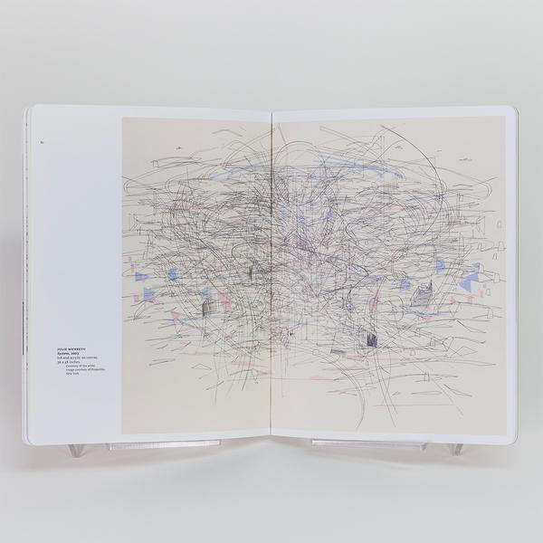 A photograph of an open book spread. There is a painting that spans both pages. The painting has a cream background and thin black gestural lines creating movement and chaos. There are pastel blue and pink shapes scattered about in the painting. The painting is by Julie Mehretu.