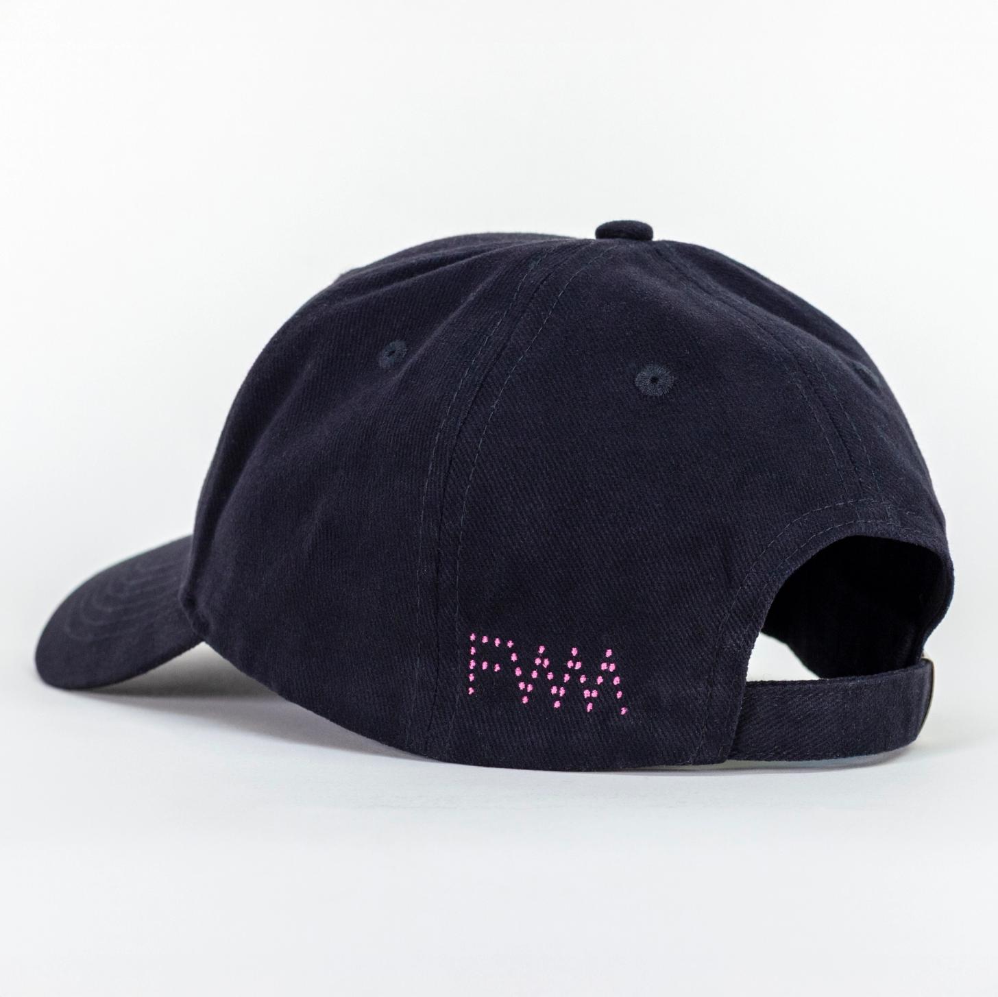 A photo of a black baseball cap. There is a pink dotted logo spelling out "FWM" on the left side of the adjustable strap.