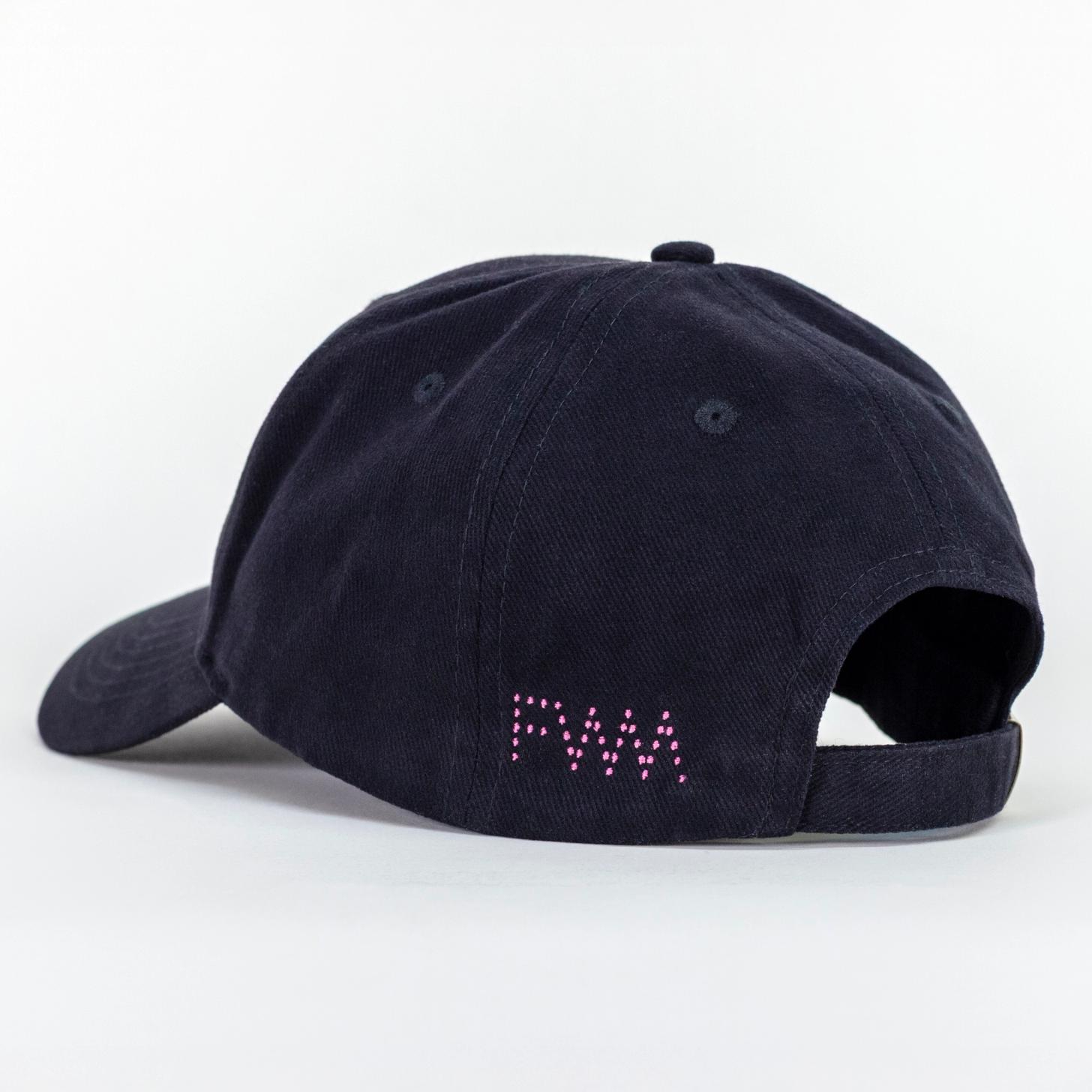 A photo of a black baseball cap. There is a pink dotted logo spelling out "FWM" on the left side of the adjustable strap.