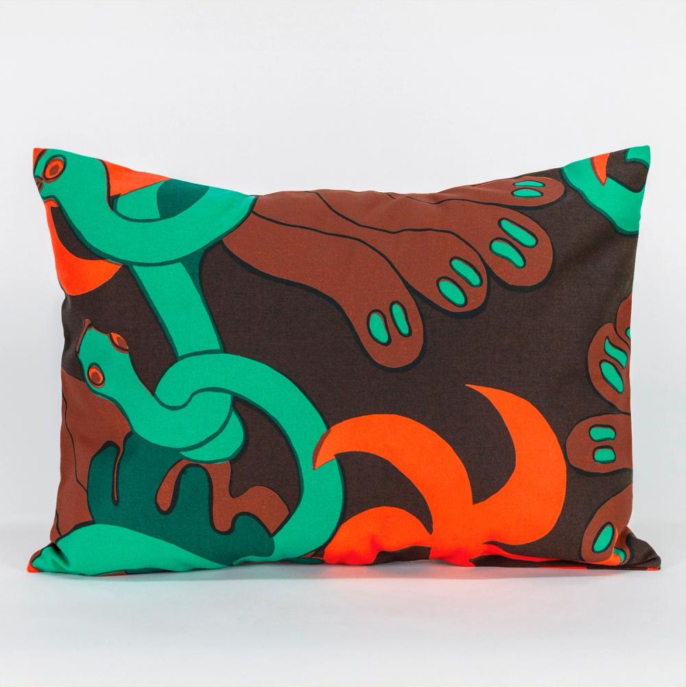 A wide rectangle-shaped pillow made of fabric featuring a repeating textile pattern with stylized green snakes intertwined with abstract brown shapes and bright orange spirals on a dark brown background.