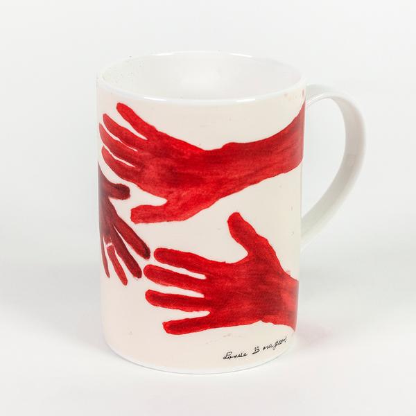 A tall cream colored mug featuring three painted red hands with fingers outstretched. The hand on top extends from a long arm.