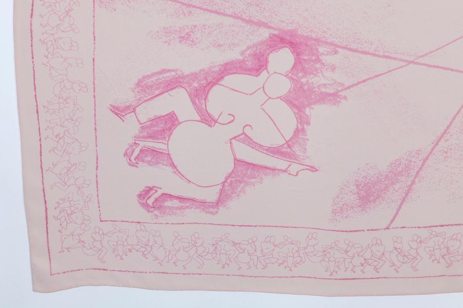 A corner detail of a light pink scarf with a cubist-style abstraction of two intertwined figures. The border features a pattern of dozens of such figures.