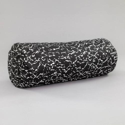 A long cylindrical pillow featuring a speckled black and white design like the kind found on a student's composition notebook.