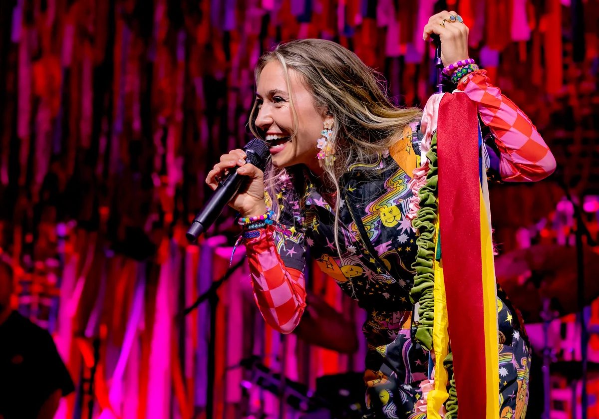 Lauren Daigle performing with a microphone at The Novo in Los Angeles